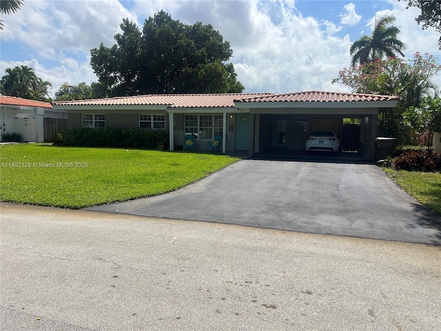 4441 NE 17th Ave, Oakland Park, FL 33334 - single story home with driveway, a front lawn, a tiled roof, and an attached carport