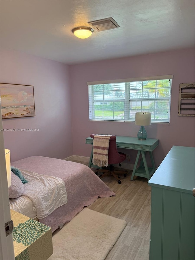 4441 NE 17th Ave, Oakland Park, FL 33334 - bedroom with multiple windows and light wood-type flooring