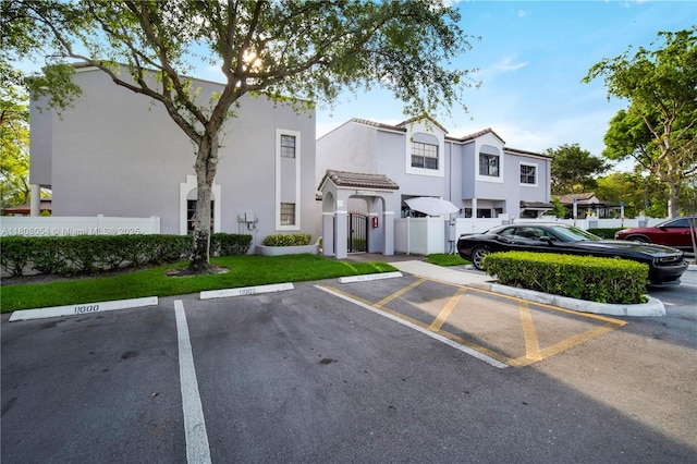 11604 NW 11th St, Pembroke Pines, FL 33026 - view of front of house with uncovered parking, stucco siding, a gate, and a tile roof