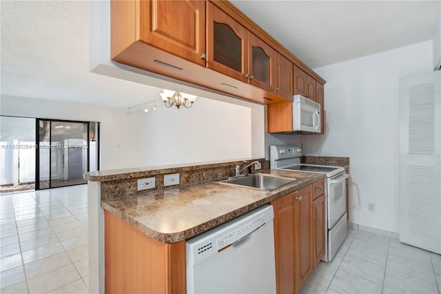 11604 NW 11th St, Pembroke Pines, FL 33026 - kitchen featuring white appliances, light tile patterned floors, a sink, glass insert cabinets, and a chandelier