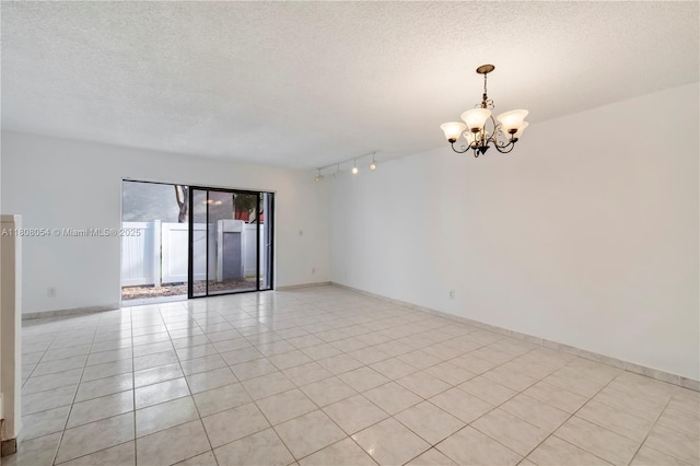 11604 NW 11th St, Pembroke Pines, FL 33026 - empty room featuring a chandelier, a textured ceiling, light tile patterned floors, baseboards, and track lighting