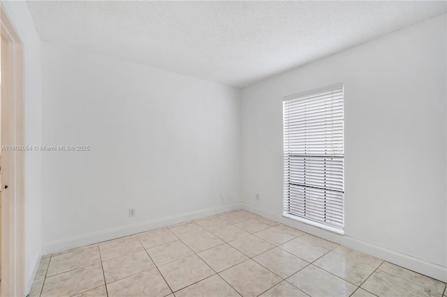 11604 NW 11th St, Pembroke Pines, FL 33026 - unfurnished room with baseboards, light tile patterned flooring, and a textured ceiling