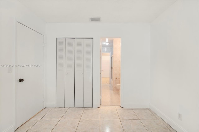 11604 NW 11th St, Pembroke Pines, FL 33026 - unfurnished bedroom with light tile patterned flooring, a closet, baseboards, and ensuite bathroom