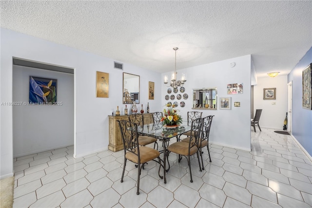 2504 Antigua Ter Unit O3, Coconut Creek, FL 33066 - dining room with a chandelier, a textured ceiling, and baseboards