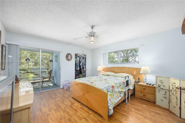 2504 Antigua Ter Unit O3, Coconut Creek, FL 33066 - bedroom featuring a textured ceiling, access to exterior, wood finished floors, a closet, and ceiling fan