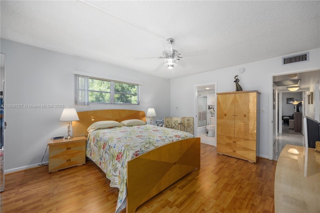 2504 Antigua Ter Unit O3, Coconut Creek, FL 33066 - bedroom featuring wood finished floors, baseboards, a textured ceiling, a ceiling fan, and ensuite bathroom