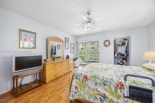 2504 Antigua Ter Unit O3, Coconut Creek, FL 33066 - bedroom with a textured ceiling, access to outside, light wood finished floors, a ceiling fan, and a closet