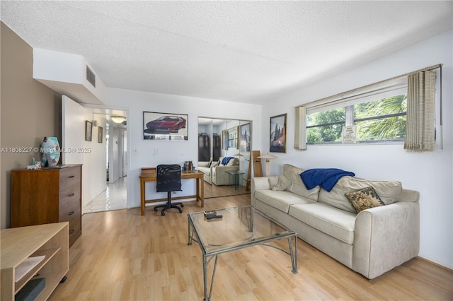 2504 Antigua Ter Unit O3, Coconut Creek, FL 33066 - living room featuring light wood-type flooring, a textured ceiling, and an office area