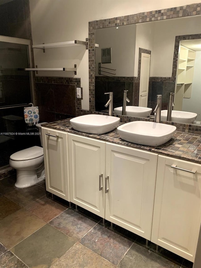 711 E Coco Plum Cir Unit 5, Plantation, FL 33324 - bathroom featuring stone tile flooring, double vanity, and toilet
