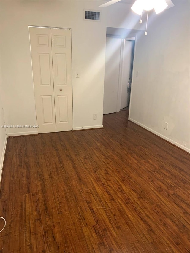 711 E Coco Plum Cir Unit 5, Plantation, FL 33324 - empty room with a ceiling fan, dark wood-style flooring, and baseboards