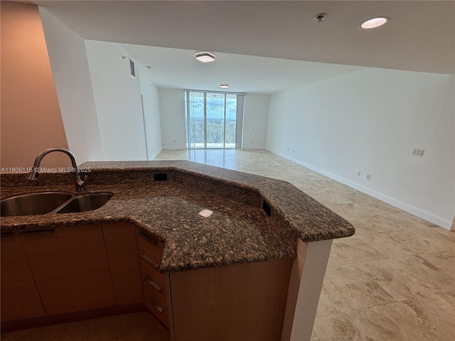 15051 Royal Oaks Ln Unit 1604, North Miami, FL 33181 - kitchen with a sink, dark stone countertops, open floor plan, and baseboards