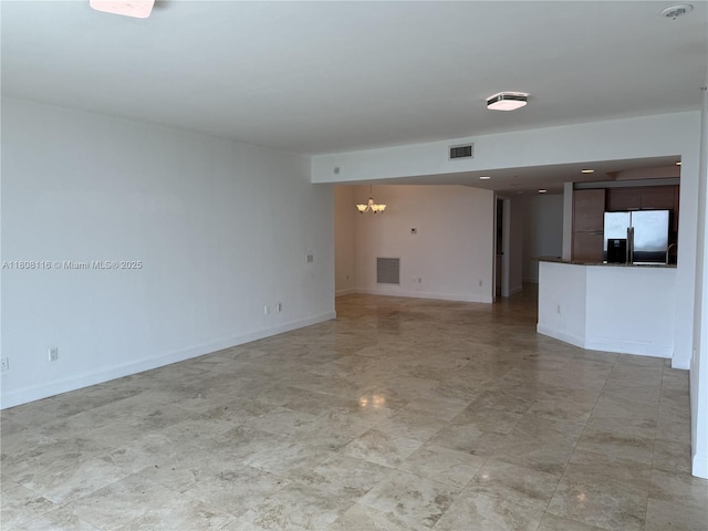15051 Royal Oaks Ln Unit 1604, North Miami, FL 33181 - unfurnished living room featuring a chandelier and baseboards