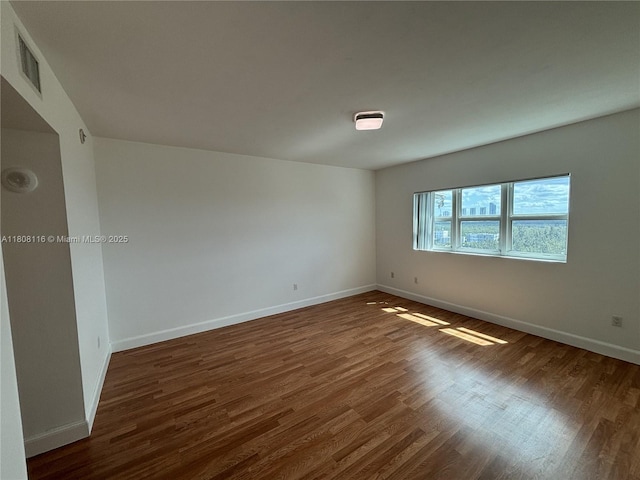 15051 Royal Oaks Ln Unit 1604, North Miami, FL 33181 - spare room featuring dark wood-style flooring and baseboards