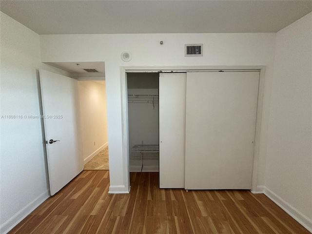 15051 Royal Oaks Ln Unit 1604, North Miami, FL 33181 - unfurnished bedroom with wood finished floors, a closet, and baseboards
