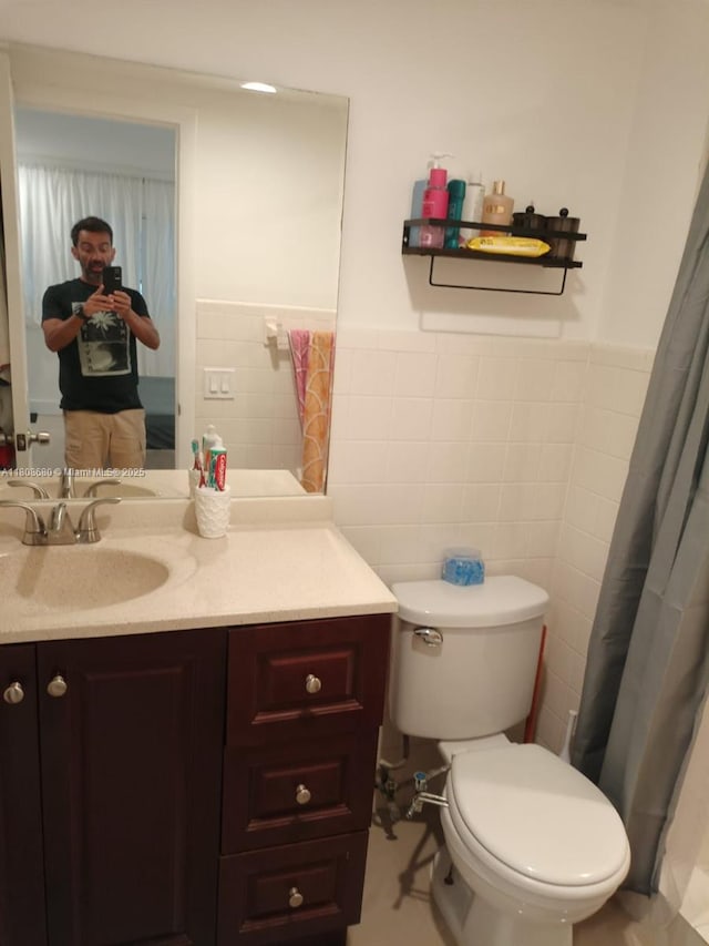 2005 Sans Souci Blvd Unit 202, North Miami, FL 33181 - full bathroom with toilet, vanity, tile walls, and wainscoting