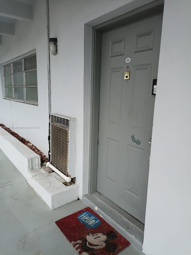 2005 Sans Souci Blvd Unit 202, North Miami, FL 33181 - property entrance with stucco siding and central AC