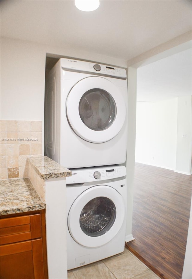 733 SE 1st Way Unit 206, Deerfield Beach, FL 33441 - washroom with estacked washer and dryer, light wood-type flooring, and cabinet space