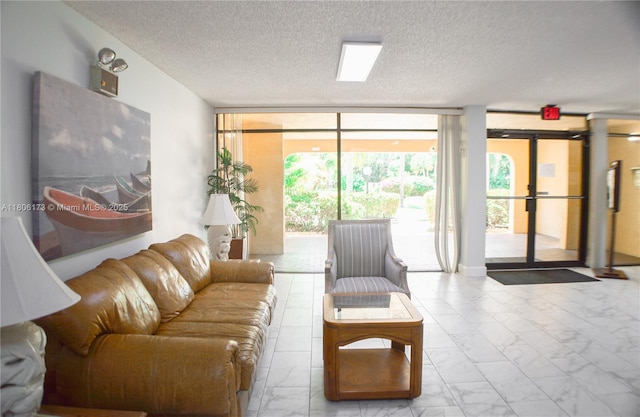 733 SE 1st Way Unit 206, Deerfield Beach, FL 33441 - living room featuring marble finish flooring, floor to ceiling windows, and a textured ceiling
