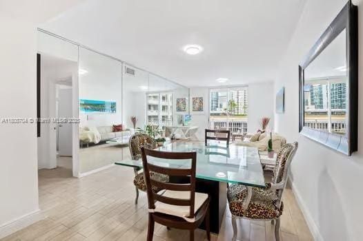 185 SE 14th Ter Unit 1410, Miami, FL 33131 - dining space with healthy amount of natural light, light wood finished floors, and baseboards