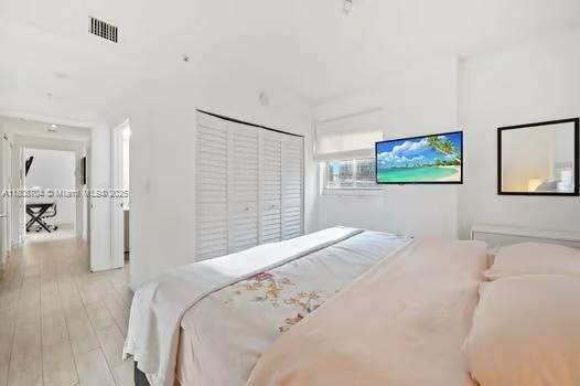 185 SE 14th Ter Unit 1410, Miami, FL 33131 - bedroom with a closet and wood finished floors