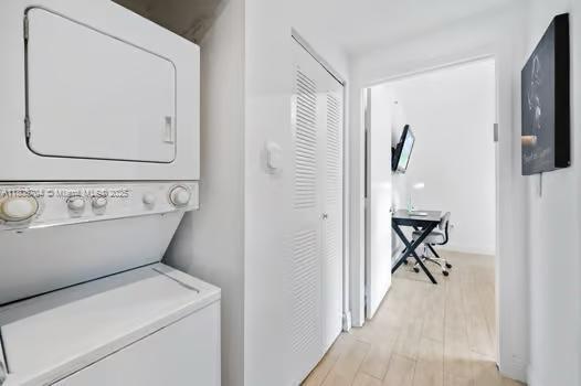 185 SE 14th Ter Unit 1410, Miami, FL 33131 - washroom with stacked washer / drying machine and light wood-style floors