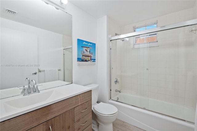 185 SE 14th Ter Unit 1410, Miami, FL 33131 - full bathroom featuring vanity, toilet, and bath / shower combo with glass door