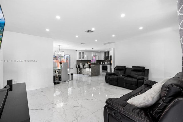 3201 NE 9th Ter, Pompano Beach, FL 33064 - living area featuring recessed lighting, a chandelier, light marble finish flooring, and baseboards