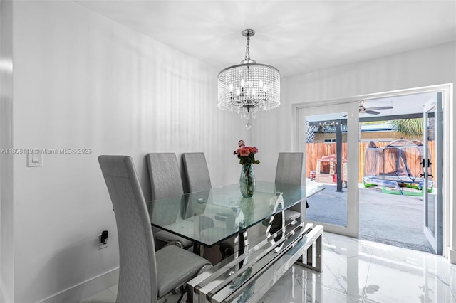 3201 NE 9th Ter, Pompano Beach, FL 33064 - dining space featuring a chandelier, a ceiling fan, and light marble finish flooring