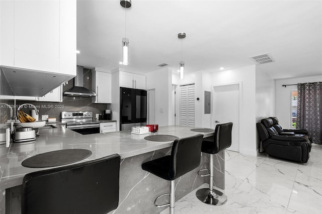 3201 NE 9th Ter, Pompano Beach, FL 33064 - kitchen with wall chimney exhaust hood, stainless steel range with electric cooktop, fridge, electric panel, and white cabinets