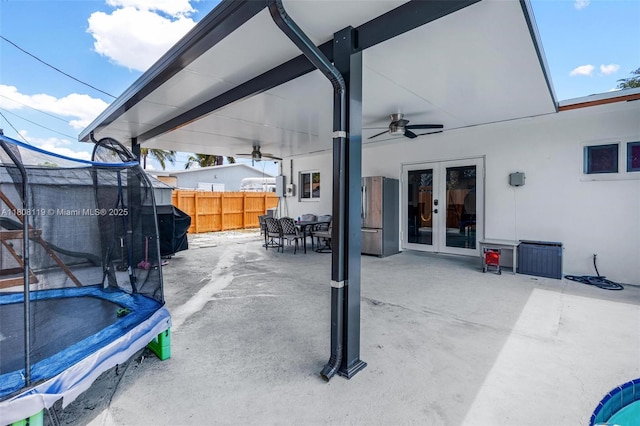 3201 NE 9th Ter, Pompano Beach, FL 33064 - view of patio featuring a trampoline, french doors, a ceiling fan, outdoor dining area, and electric panel