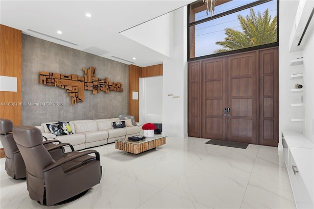 12880 N Bayshore Dr, North Miami, FL 33181 - living area featuring recessed lighting, marble finish floors, and a towering ceiling
