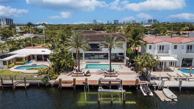 12880 N Bayshore Dr, North Miami, FL 33181 - view of subject property featuring a pool and a large body of water