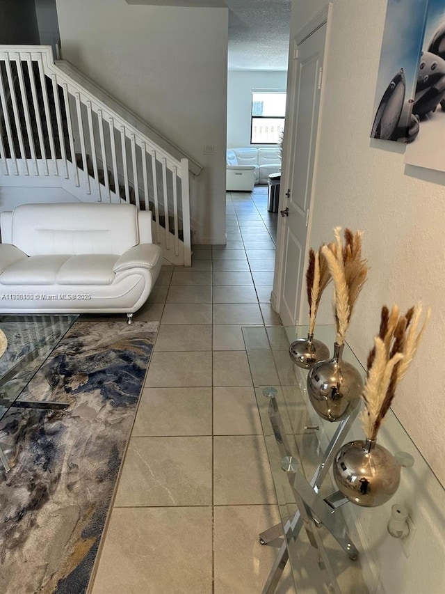 13383 SW 287th Ter, Homestead, FL 33033 - hallway featuring tile patterned flooring, a textured ceiling, and baseboards
