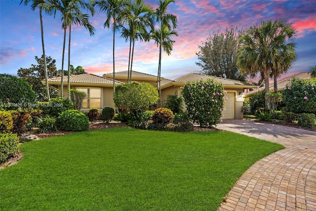 11034 Via, San Remo, Boynton Beach, FL 33437 - view of front facade featuring stucco siding, a tiled roof, a garage, and decorative driveway