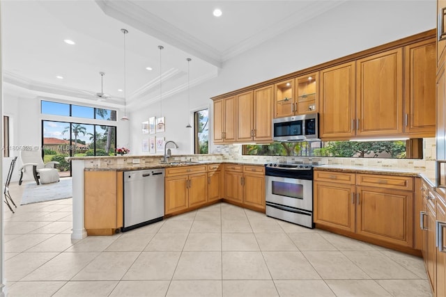 11034 Via, San Remo, Boynton Beach, FL 33437 - kitchen featuring appliances with stainless steel finishes, a sink, a peninsula, backsplash, and ornamental molding