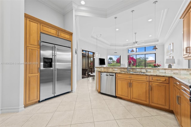 11034 Via, San Remo, Boynton Beach, FL 33437 - kitchen featuring stainless steel appliances, a sink, brown cabinetry, light stone counters, and pendant lighting