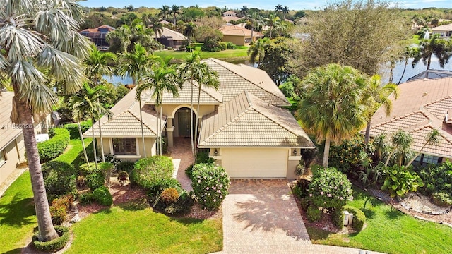 11034 Via, San Remo, Boynton Beach, FL 33437 - view of front facade with a tile roof, decorative driveway, stucco siding, a garage, and a residential view