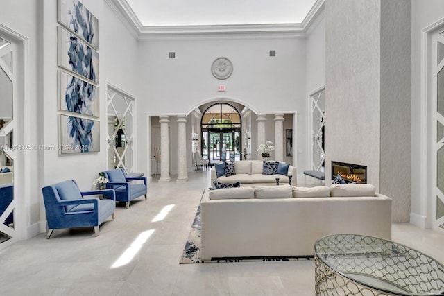 11034 Via, San Remo, Boynton Beach, FL 33437 - living room with decorative columns, ornamental molding, a high ceiling, and a glass covered fireplace