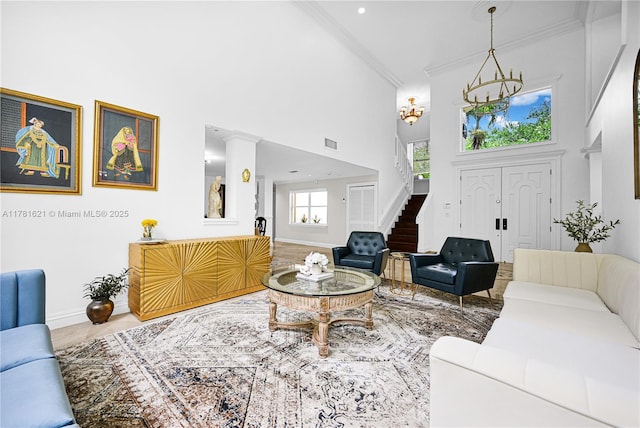 9866 SW 111th Ter, Miami, FL 33176 - living room with a towering ceiling, crown molding, baseboards, stairway, and a chandelier