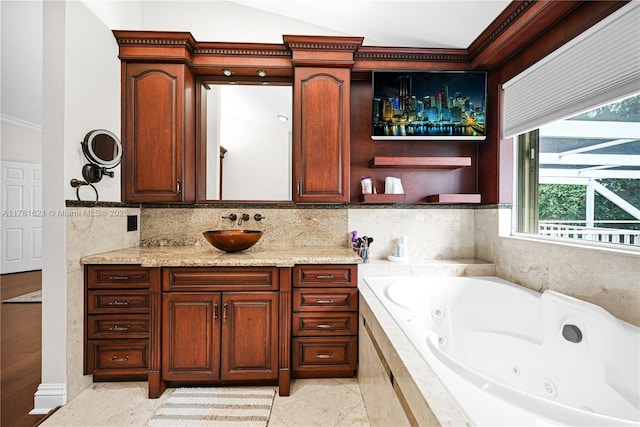 9866 SW 111th Ter, Miami, FL 33176 - bathroom with a tub with jets, vanity, vaulted ceiling, and backsplash