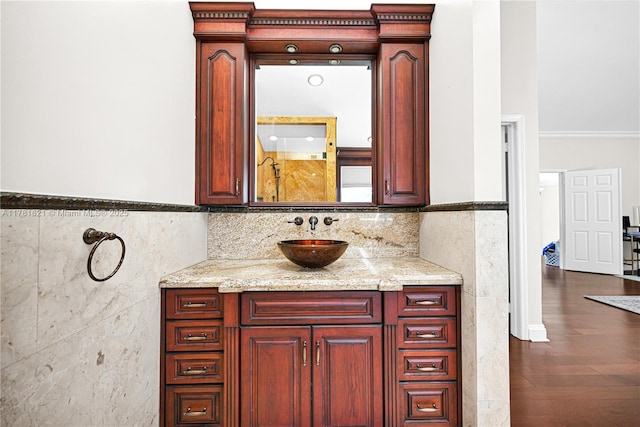 9866 SW 111th Ter, Miami, FL 33176 - bathroom featuring tile walls, vanity, wainscoting, wood finished floors, and ornamental molding