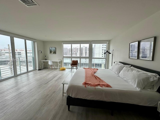 19380 NE 26th Ave Unit 301, Miami, FL 33180 - bedroom featuring light wood-type flooring and access to outside