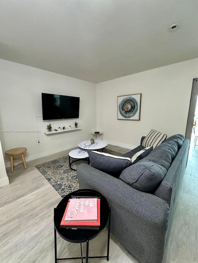 19380 NE 26th Ave Unit 301, Miami, FL 33180 - living room with wood finished floors and baseboards