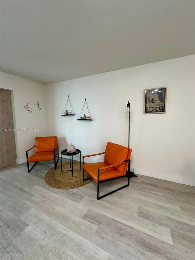 19380 NE 26th Ave Unit 301, Miami, FL 33180 - sitting room with wood finished floors and baseboards