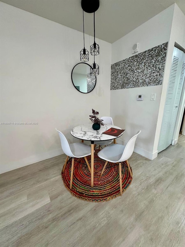 19380 NE 26th Ave Unit 301, Miami, FL 33180 - dining area with wood finished floors and baseboards