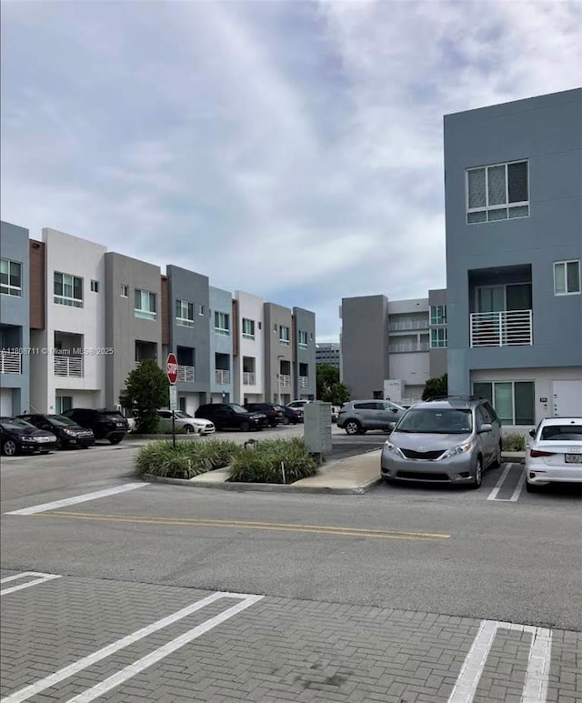 19380 NE 26th Ave Unit 301, Miami, FL 33180 - view of building exterior featuring uncovered parking and a residential view