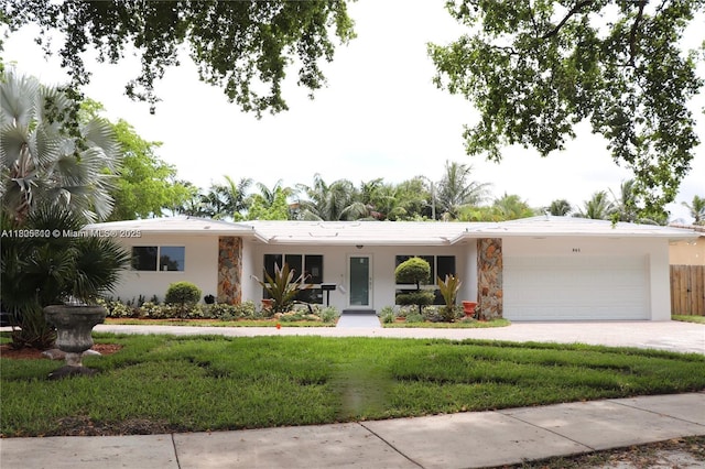861 N Rainbow Dr, Hollywood, FL 33021 - single story home with a garage, a front lawn, stone siding, concrete driveway, and stucco siding