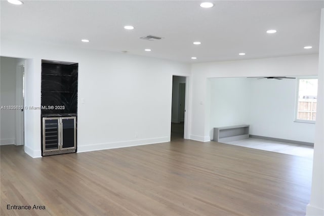 861 N Rainbow Dr, Hollywood, FL 33021 - unfurnished room featuring light wood-type flooring, recessed lighting, baseboards, and wine cooler