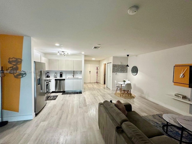 19380 NE 26th Ave Unit 305, Miami, FL 33180 - living area with light wood-style floors and baseboards