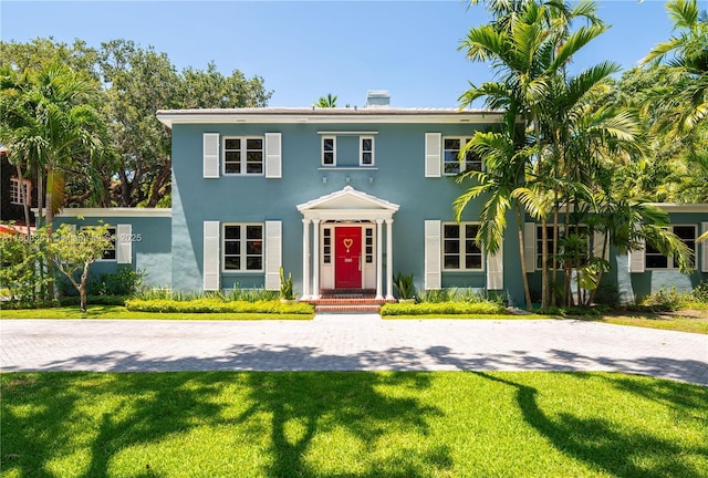 3245 Riviera Dr, Coral Gables, FL 33134 - colonial house with a front lawn and stucco siding